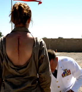 THE MYTH OF THE THREE BLADES: They called me a beggar, a fraud, a civilian playing dress-up on a scorching American military base. They tore the insignias from my faded uniform, paraded me in front of hundreds of sneering troops, and demanded proof I was a soldier. But when the young Captain ripped my shirt open, revealing the razor-sharp, parallel scars etched across my spine—the silent, sacred ritual marks of a unit that officially doesn’t exist—the base went silent. A three-star General froze, dropped to one knee, and bowed his head in sheer, unadulterated terror. He didn’t see a woman; he saw a ghost who walked back from the fire to deliver a single, chilling black chip. This is the story of how three scars and a single moment of defiant silence shut down Fort Ramsay and exposed the dark truth behind the legendary Black Echo.
